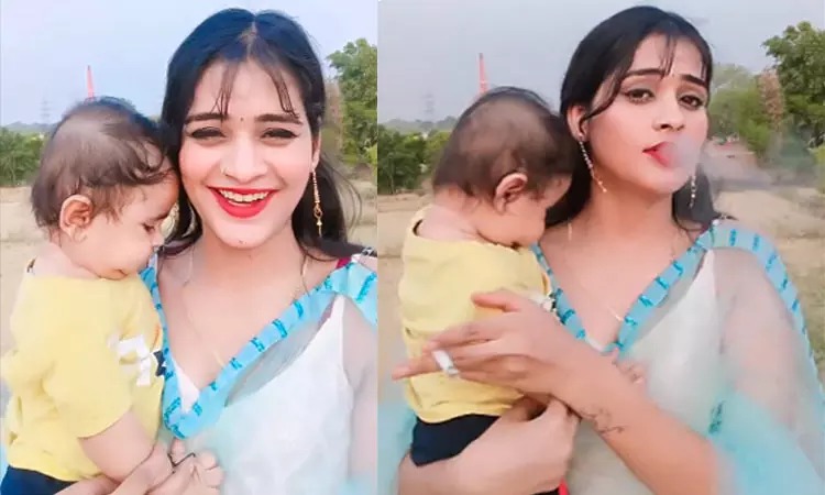 கையில் குழந்தை, வாயில் சிகரெட்….. மூச்சு திணறிய குழந்தை…. இளம்பெண் வீடியோவால் அதிர்ச்சி….!!