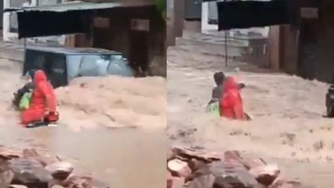 வெள்ளத்திற்கு நடுவே தாயுடன் பைக்கில் வந்த மகன்…. அதிவேகமாக வந்த கார்…! அடுத்து நடந்த அதிர்ச்சி சம்பவம்…. பதற வைக்கும் வீடியோ….!!