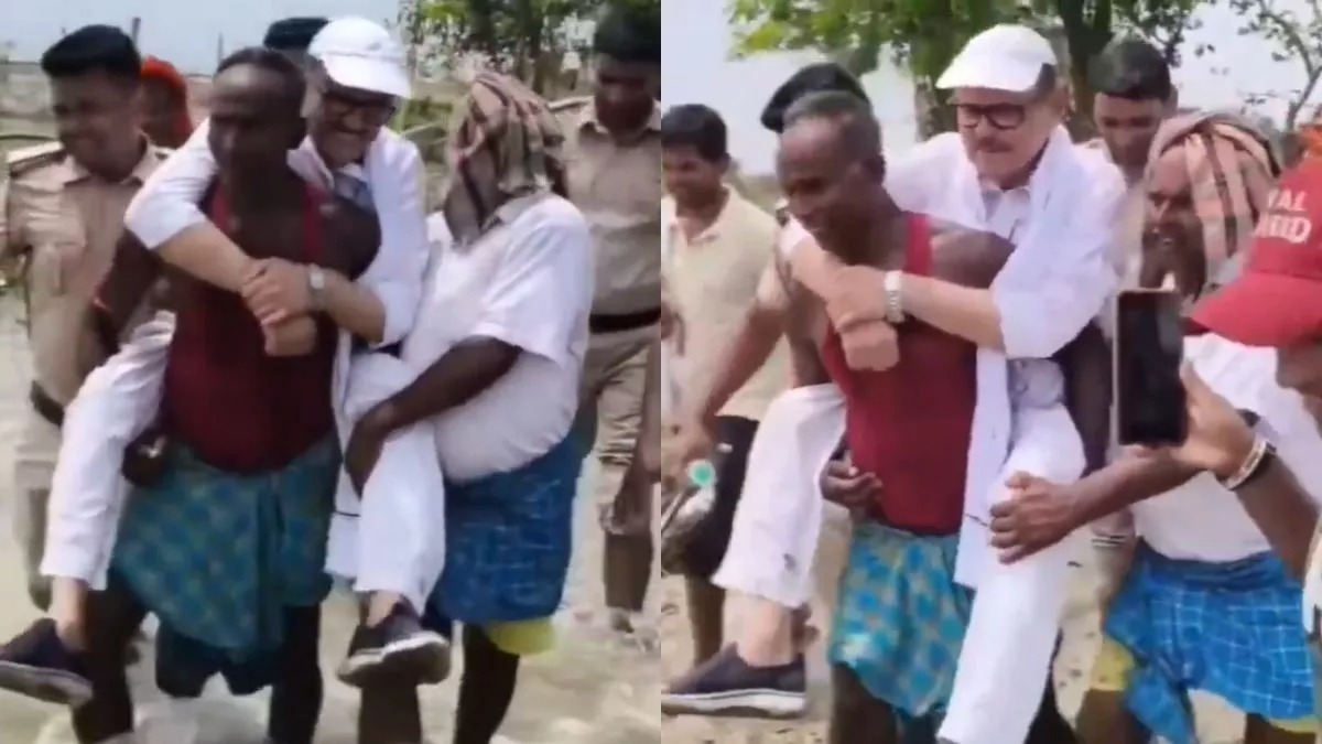அடக்கெடுமையே…!! “பொதுமக்கள் தோளில் ஏறி‌ வெள்ள பாதிப்பை ஆய்வு செய்த எம்பி… பின்னால் சென்ற போலீசார்… வைரலாகும் சர்ச்சை வீடியோ..!!