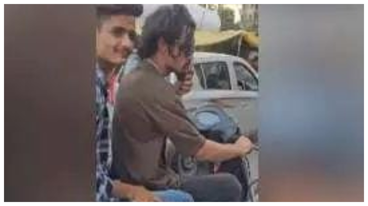 சாலையில் ஸ்கூட்டரில் சென்ற இளைஞர்கள்…. கழுத்தில் விஷ பாம்பை மாட்டிக்கொண்டு முத்தமிட்டு…. வைரலாகும் அதிர்ச்சி வீடியோ…!!!