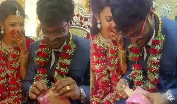 அப்படி உள்ள என்னதான் இருந்திருக்கும்..! வெட்கத்தில் சிவந்த மணமகள்.. பரிசை சட்டுன்னு ஒளித்து வைத்த மணமகன்… டிரெண்டாகும் வீடியோ…!